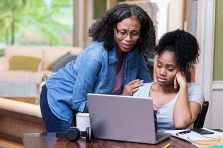 Mother and daughter looking at computer