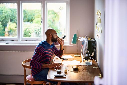  Photo of man sitting at computer