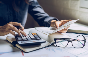 Man using calculator at table