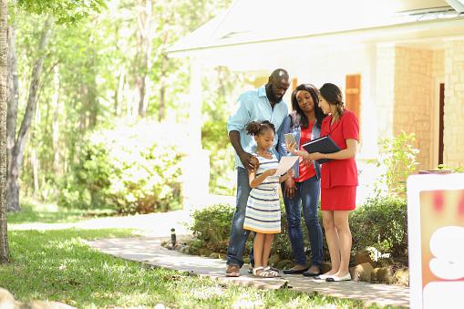 Family meeting with realtor outside home