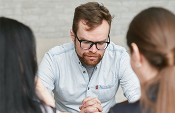 man and two women talking