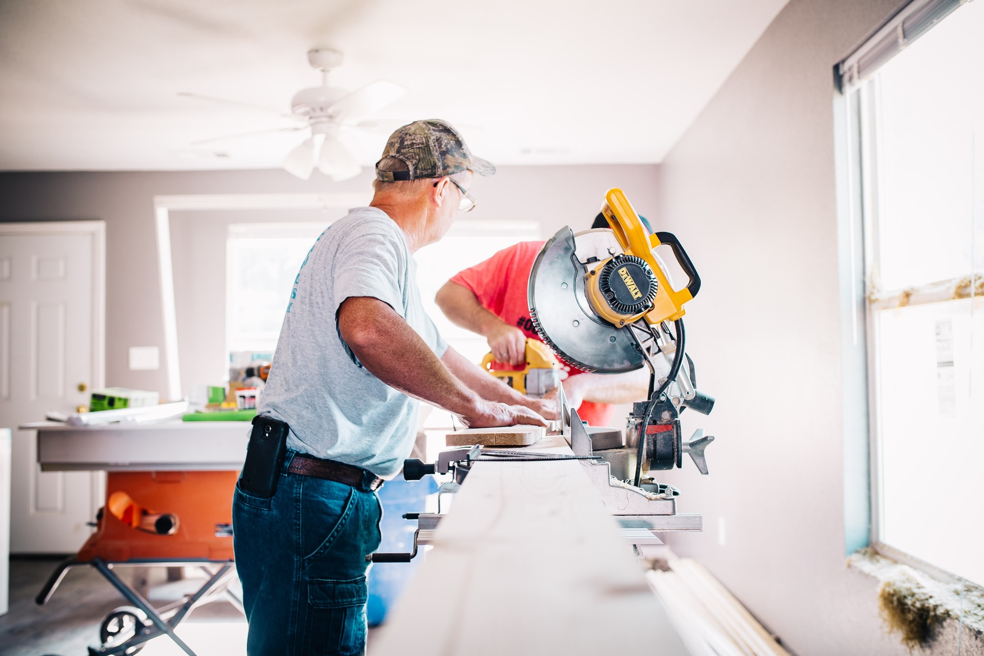 Construction worker using saw