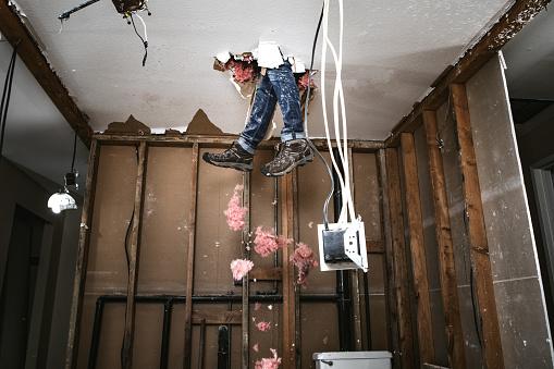 Legs coming through ceiling undergoing repair