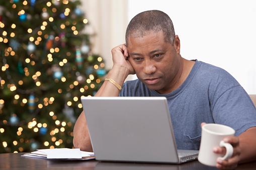 man on laptop computer looking worried